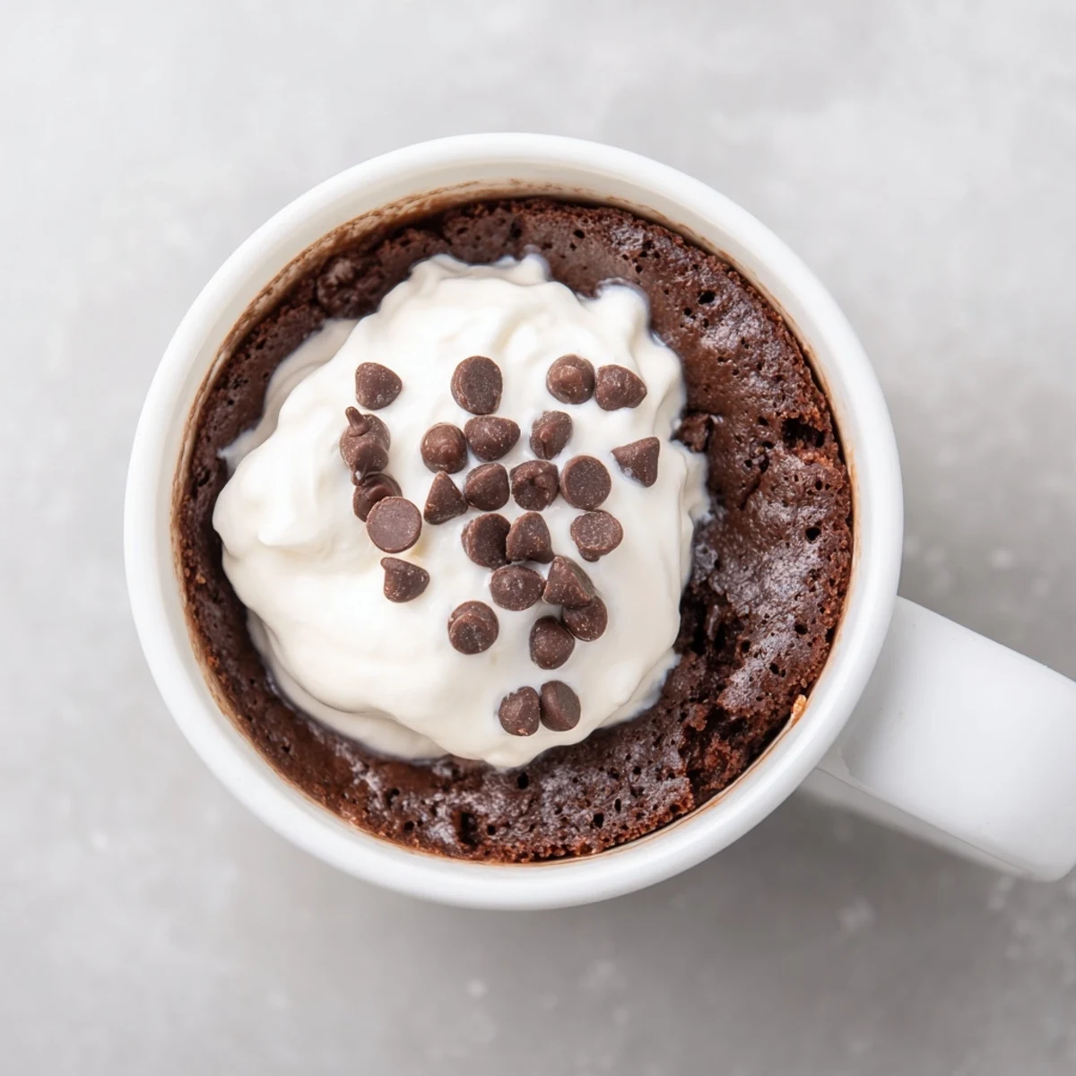 Fluffy and delicious chocolate mug cake with optional chocolate chips, a perfect dessert pictured.