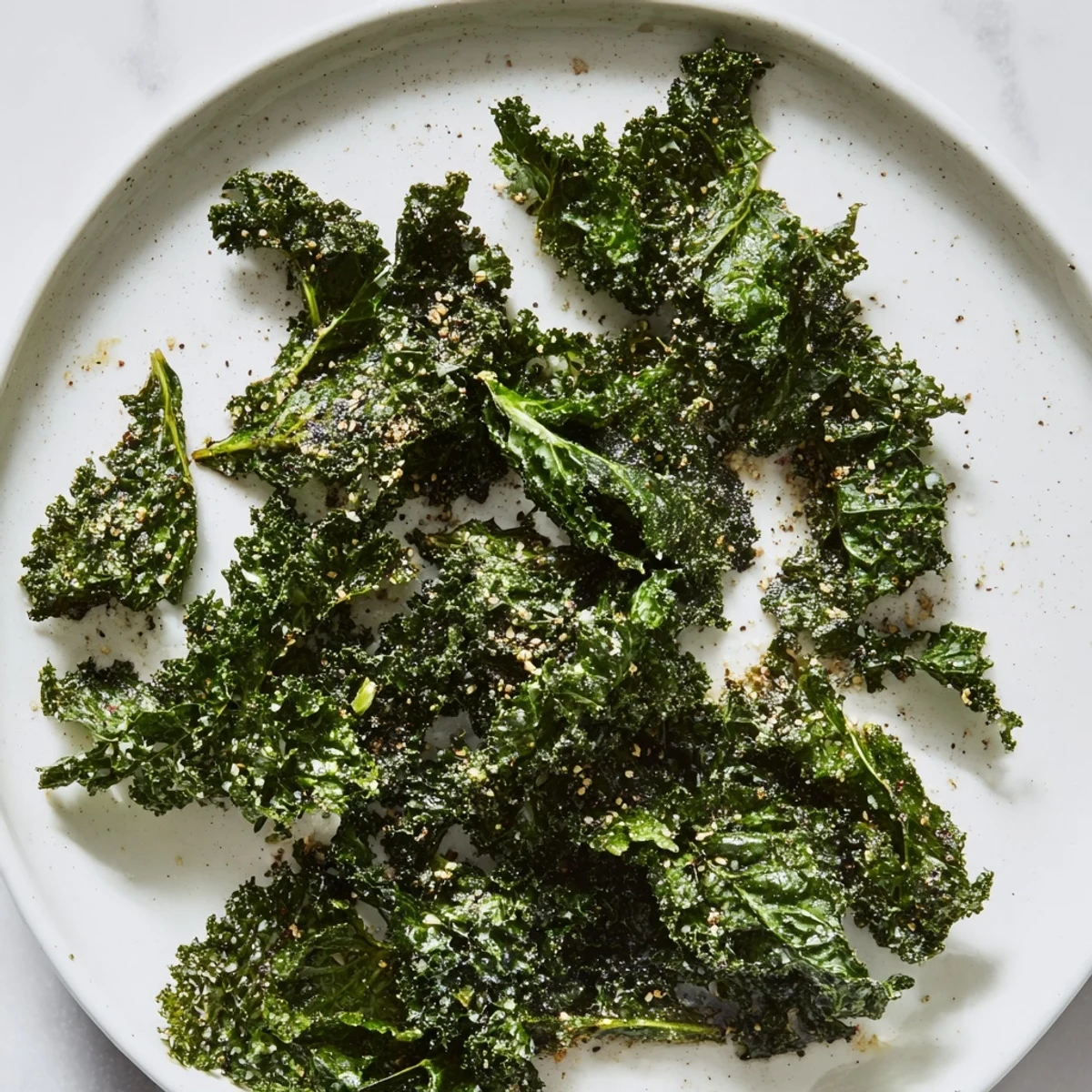 Freshly seasoned crispy kale chips, a baked snack with smoky paprika and garlic flavors.