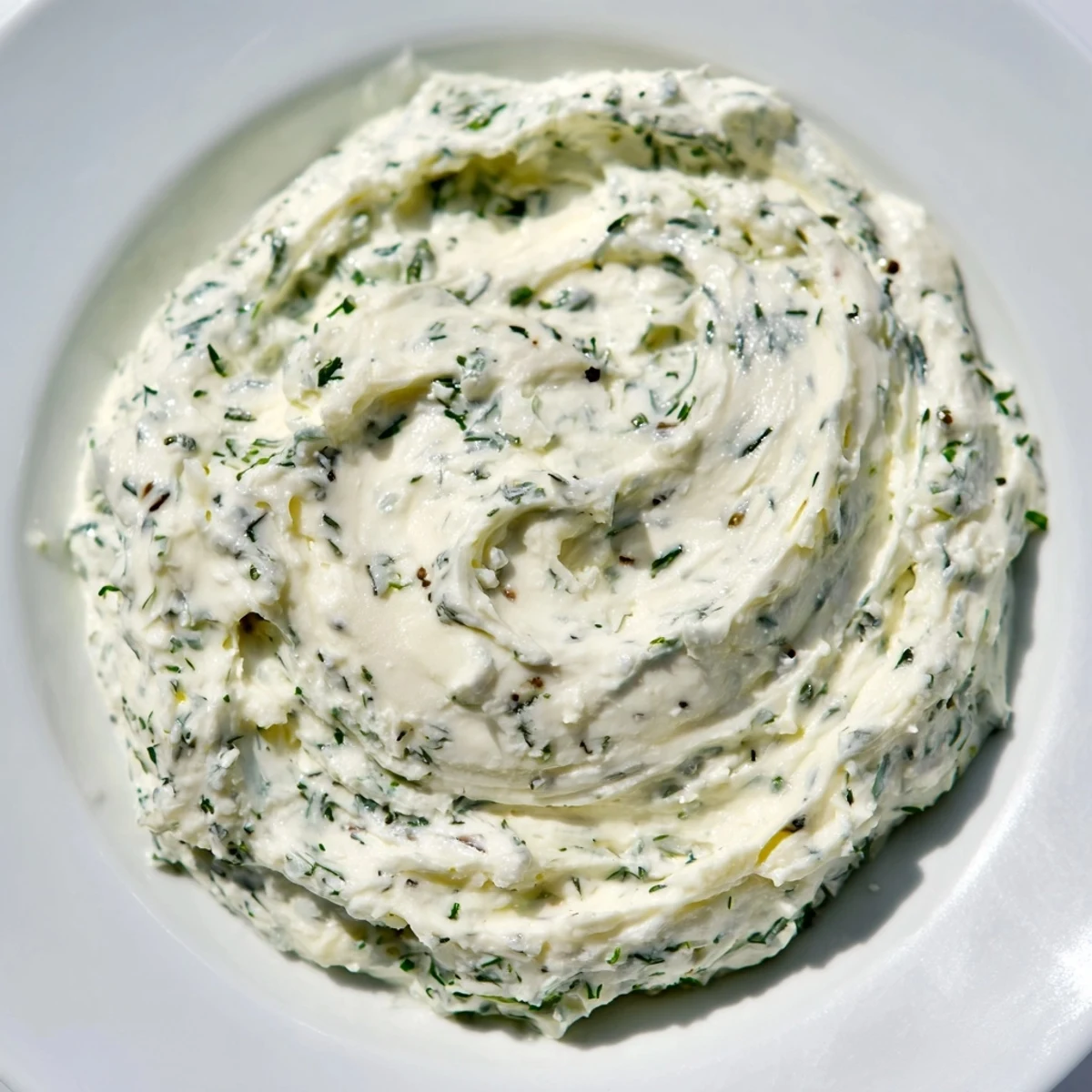Creamy Greek Yogurt Herb Dip, speckled with fresh herbs, ready for dipping vegetables.