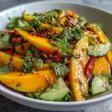 A vibrant, Thai-inspired bowl of Refreshing Mango Salad with Lime Dressing, juicy mango ribbons and crunchy veggies in a tangy honey-lime vinaigrette.