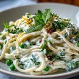 Delicious pan of Lemon Ricotta Pasta, bright lemon, sweet peas, mint.