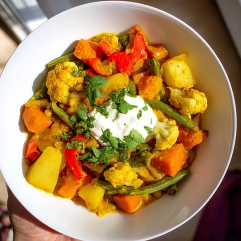 A steaming bowl of Waste-Free Vegetarian Curry, served over fluffy rice and garnished with fresh cilantro.