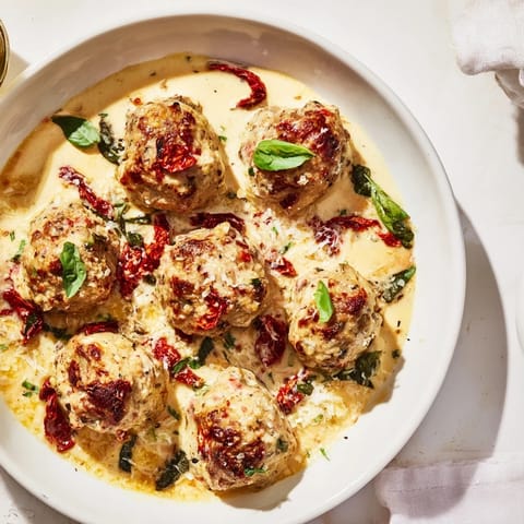 The delicious Marry Me Chicken Meatballs, perfectly browned and nestled in a rich, velvety sauce, look irresistible.