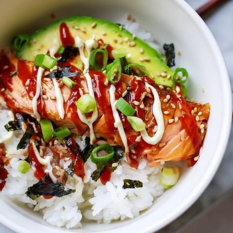 Imagine a vibrant bowl of Classic Salmon Rice, with creamy avocado and toasted sesame seeds ready.