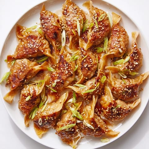 Golden-brown air fryer frozen dumplings with sesame seeds, a quick Asian-inspired snack ready to enjoy.