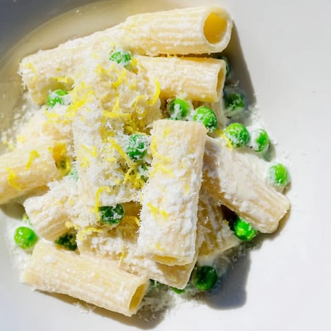 Freshly grated lemon zest and basil garnish this vibrant Pea & Lemon Ricotta Pasta, perfect for spring.
