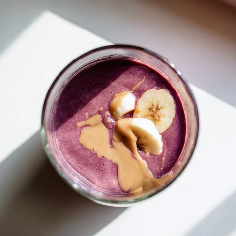 This Cherry Almond Smoothie features tart cherries and almond butter blended until velvety, topped with fresh almond slices.