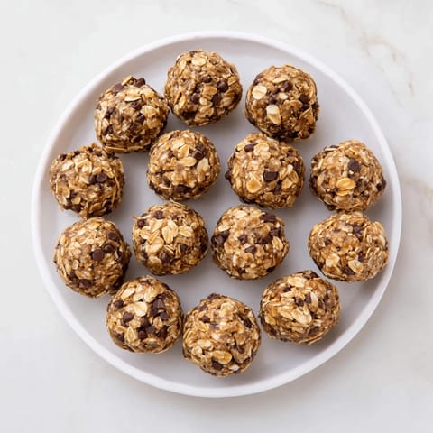 A close-up of homemade Banana Chocolate Chip Energy Balls, featuring oats, chocolate chips, and a hint of banana.