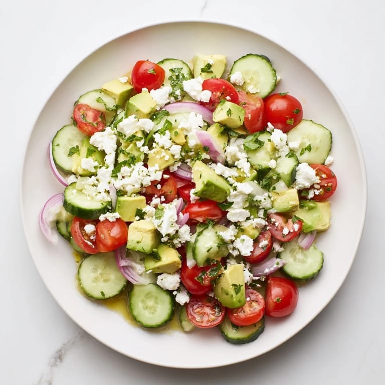 This Fresh Cucumber, Tomato, and Avocado Salad features ripe avocados, bursting tomatoes, and creamy feta cheese.
