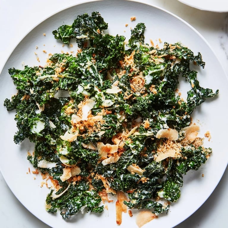 Tender kale leaves coated in tangy lemon-garlic dressing, sprinkled with crisp panko and extra Parmesan for a satisfying side.