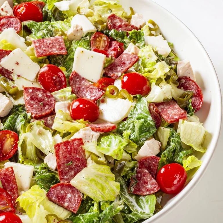 A close-up of Italian Deli Chopped Chicken Salad featuring chopped chicken, pepperoncini, and a tangy herb vinaigrette.  