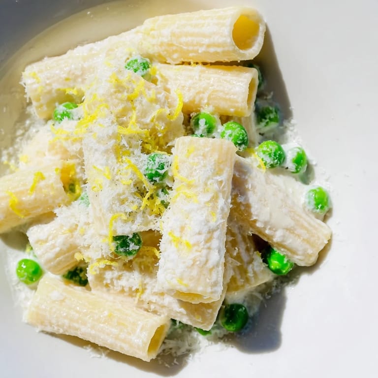 Freshly grated lemon zest and basil garnish this vibrant Pea & Lemon Ricotta Pasta, perfect for spring.