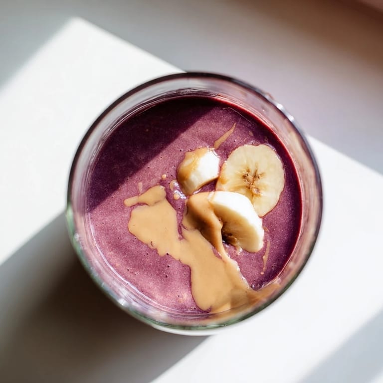 This Cherry Almond Smoothie features tart cherries and almond butter blended until velvety, topped with fresh almond slices.