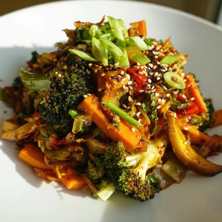 Steaming hot comforting fermented veggie winter stir-fry with sautéed carrots and parsnip, finished with a spoonful of tangy probiotic-rich kimchi.