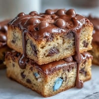 Chewy blondies loaded with Cadbury Mini Eggs and drizzled with smooth white chocolate, perfect for spring baking.  