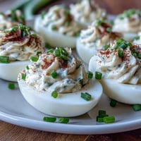 Everything Bagel Deviled Eggs with Cream Cheese: Creamy, tangy deviled eggs topped with savory everything bagel seasoning and fresh chives.